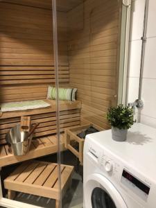 a sauna with a washing machine in a room at Lake view Helmi in Jyväskylä
