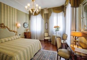 una camera con letto, tavolo e sedie di Locanda Vivaldi a Venezia