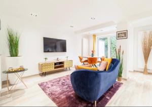 a living room with a blue couch and a table at COZY APARTMENT IN BRUSSELS in Brussels