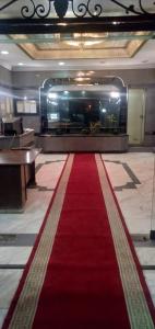 a red carpet in a lobby with a large aquarium at Nile Star Suites &Apartment in Cairo