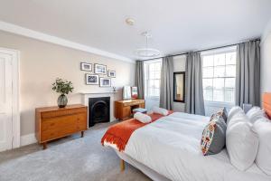 a bedroom with a large bed and a fireplace at Abbey View in Bath