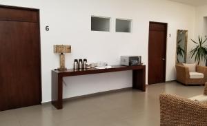 a room with a desk with a lamp and a chair at Hotel Parga in Aguascalientes