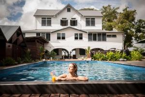 a woman laying in a swimming pool in a house at Boutique Hotel Peperpot in Meerzorg