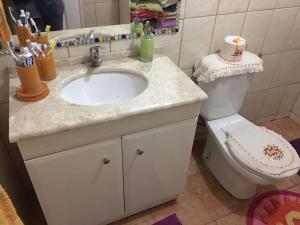 uma casa de banho com um lavatório e um WC em Hospedaje Familiar Glady's House em Puerto Montt
