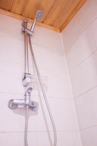 y baño con ducha y cabezal de ducha. en Viesu nams Jaunzilakši, en Vireši