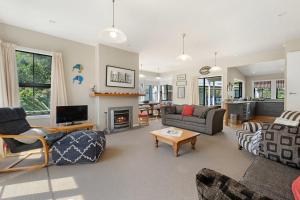 a living room filled with furniture and a fireplace at Lavender Country Cottage - Arrowtown Holiday Home in Arrowtown
