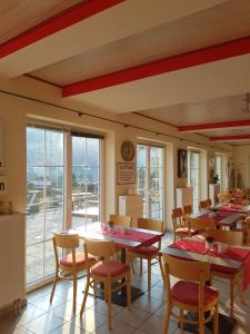 a restaurant with tables and chairs and a large window at Eisenbahnwelten in Kurort Rathen