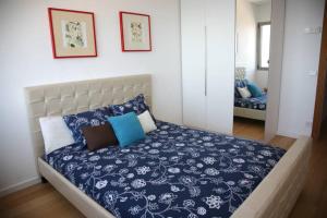 a bedroom with a bed with blue and white sheets at Villa Blau de Lluna in Port de Soller