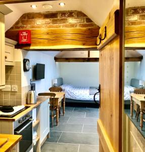 a kitchen with two beds and a table and chairs at The Outhouse - Ground Floor Studio in Melbourne