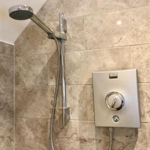 a shower in a bathroom with a shower head at The Outhouse - Ground Floor Studio in Melbourne