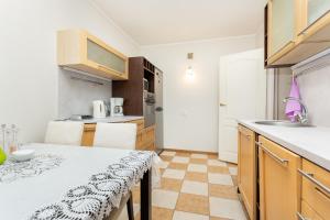 a kitchen with a table and a counter top at 3 room central apartmend 90m2 parking for one car in Tallinn