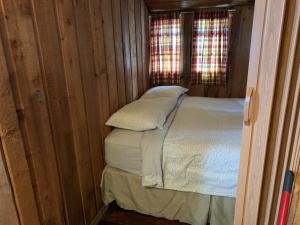 a bed in a room with a wooden floor at Rundle Chalets in Canmore