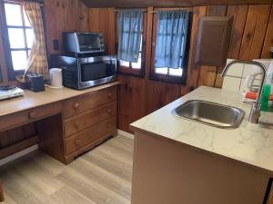 a kitchen with a sink and a microwave at Rundle Chalets in Canmore