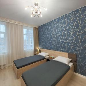 Posteľ alebo postele v izbe v ubytovaní 3 bedroom, 2 bathroom Apartment near Forum Lviv