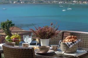 a table with food on it with a view of the ocean at Thea Family Apartment 2 in Yénion