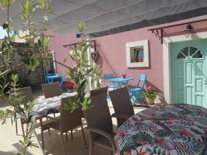 a patio with a table and chairs and a dining room at Villa Claudia in Fažana