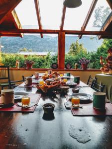 a table with food on top of it in a room at Las Rosas Alojamiento Turistico in Villa La Angostura
