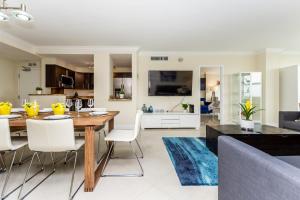 a dining room and living room with a table and chairs at Ocean Beach Condo 3BR On the Sand 811 in Fort Lauderdale