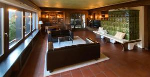 a living room with couches and tables and windows at Schwarzwald-Villa mit Indoor-Pool in Feldberg