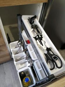 an open refrigerator drawer filled with lots of utensils at Le studio de Molière DELUXE in Montluçon