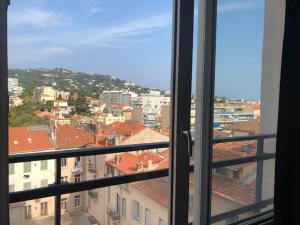a view of a city from an open window at Studio CENTRE CROISETTE in Cannes