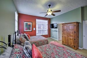 a bedroom with two beds and a ceiling fan at Arts and Design District Condo Steps to Monon Trail in Carmel