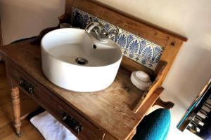 a bathroom with a white sink on a wooden counter at Dunsley Cottage in Staithes