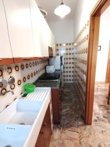 a kitchen with a sink and a wall of pipes at Appartamento CUPRA in Cupra Marittima