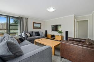 a living room with two couches and a coffee table at Maison de Maude - Lake Hawea Holiday Home in Lake Hawea