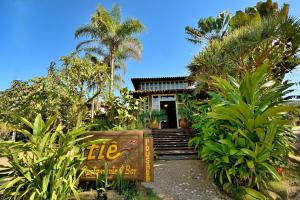 a resort with a sign in front of a building at Pousada Tiê Sahy in Barra do Sahy