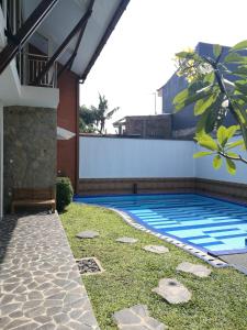 a swimming pool in the backyard of a house at Jogja City Residence in Yogyakarta