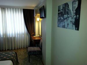 a hotel room with a bed and a desk at Avlonya Hotel in Istanbul