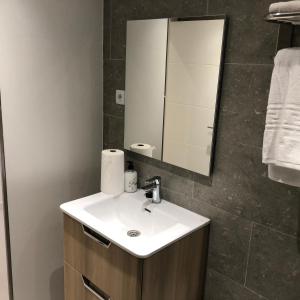 a bathroom with a sink and a mirror at Brazan Holidays in Corralejo