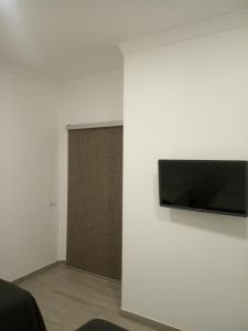 a wall with a flat screen tv on a wall at Brazan Holidays in Corralejo