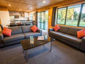 a living room with two couches and a coffee table at Motueka Apartment in Motueka