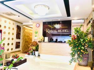 a restaurant with a counter and flowers in a store at The Royal Hotel Near West Lake in Hanoi