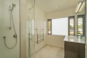 a bathroom with a shower and a sink at Matarangi Marvel - Matarangi Holiday Home in Matarangi +20 photos