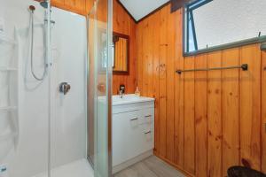 a bathroom with a shower and a sink at Downtown Mountview - Mt Maunganui Holiday Home in Mount Maunganui +14 photos