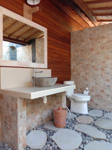 a bathroom with a sink and a toilet at Pondok Lembongan in Nusa Lembongan