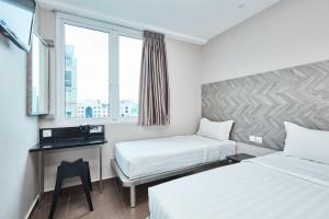 เตียงในห้องที่ ibis budget Singapore Ruby