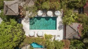 an aerial view of a swimming pool with clocks on it at The Pavilions Bali in Sanur