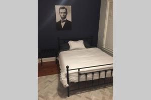 een slaapkamer met een bed met een portret van een man bij President's Residence in Washington