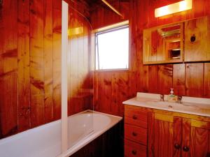 a bathroom with a tub and a sink at Ti Kouka Chalet - Ohakune Holiday Home in Ohakune