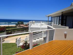 a balcony of a house with a view of the ocean at CodsView Beach House in Pennington