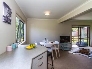 a kitchen with a sink and a table with bananas on the counter at Escape on Alpine - Ohakune Holiday Home in Ohakune
