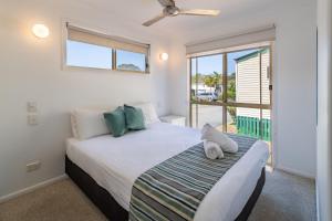 a bedroom with a bed and a large window at Ingenia Holidays Kingscliff in Chinderah