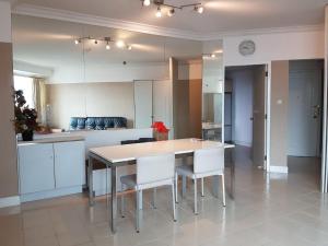 a kitchen with a table and chairs in a room at Batavia apartemen in Jakarta