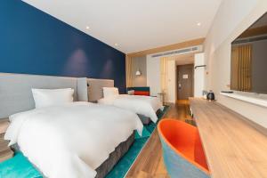 Postel nebo postele na pokoji v ubytování Holiday Inn Express Yichang Riverside by IHG