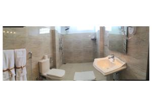 a bathroom with a toilet and a sink at Nilaveli Beach Resort - Level 1 Certified in Nilaveli