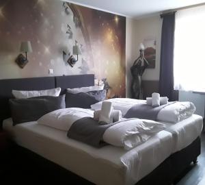 a large bed with two white pillows on it at Lieth-Hotel-Grünreich in Bad Fallingbostel